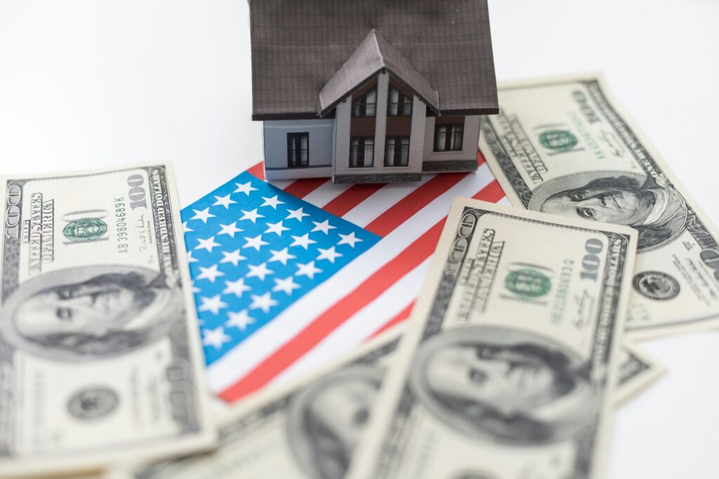 House symbol on American flag. Mortgage credit lending. Housing safety.