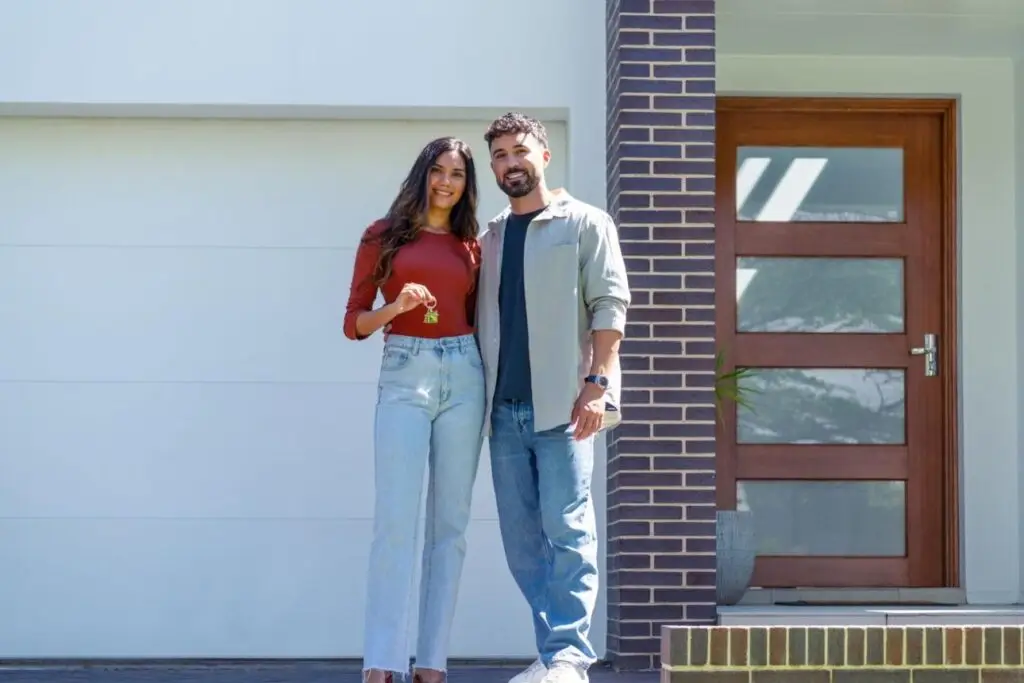 Couple in front of their new home